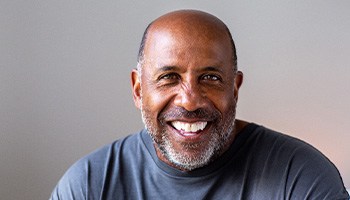 Senior man smiling in gray shirt