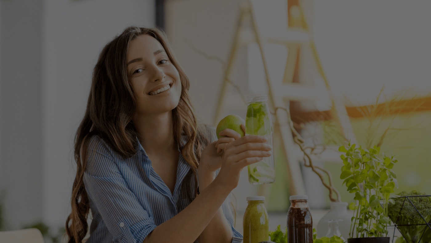 Smiling woman eating an apple