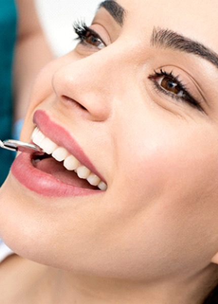 Woman receiving dental checkup in South Portland