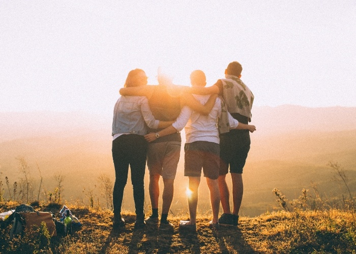Group of people together watching sunset