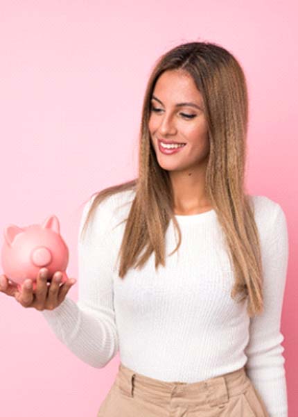 woman with a piggy bank understanding the cost of cosmetic dentistry in South Portland