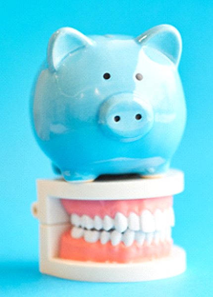 piggy bank on teeth showing how savings with a Delta Dental dentist in South Portland