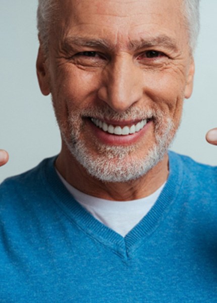 An older man pointing out her beautiful smile