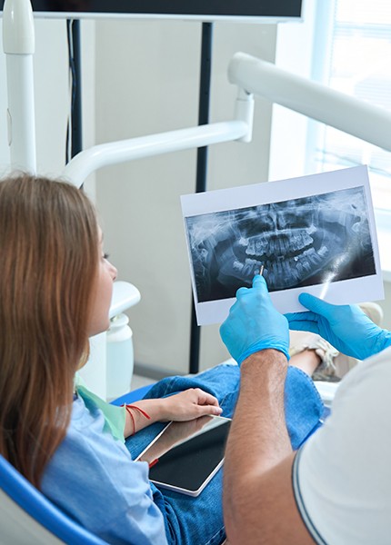 Dentist explaining the cost of tooth extraction in South Portland