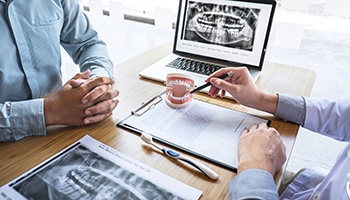 Dentist discussing factors with patient