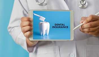 Dentist holding table that reads Dental Insurance