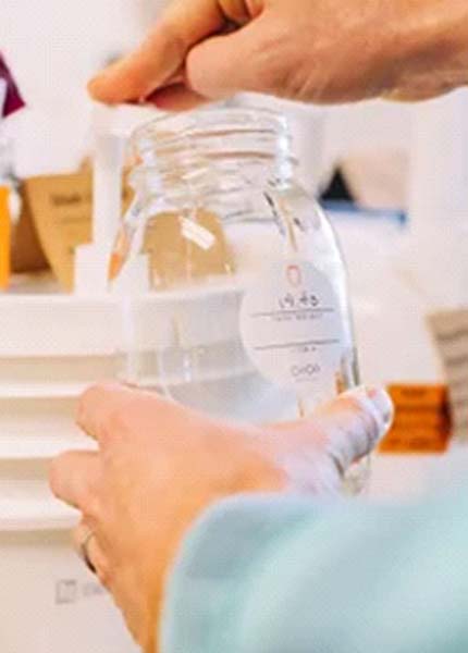 GoGo Refill filling up a glass container with hand soap