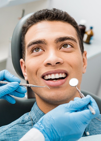 Man receiving dental checkup to preventive dental emergencies