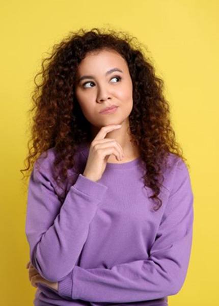 Young woman with thoughtful, curious expression on her face