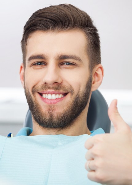 man smiling at dentist office