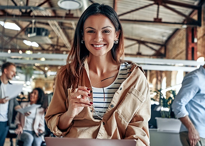 Woman sharing healthy smile after preventive dentistry