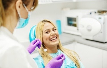 Laughing woman receiving preventive dentistry