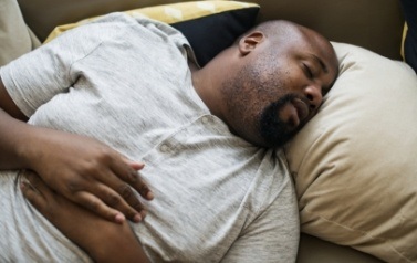 Man sleeping soundly thanks to sleep apnea treatment