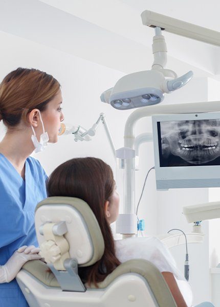 Dentist and patient looking at digital x-rays