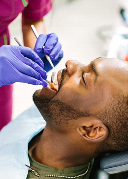 Dentist examining patient's mouth