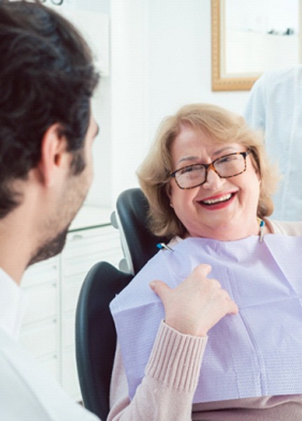 Woman smiling at dental team