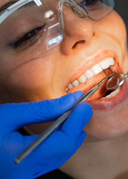 dentist looking into patient’s mouth 
