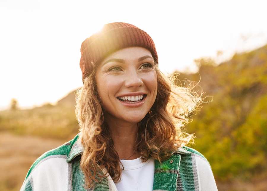 a smiling person hiking 