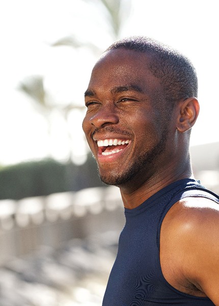  a person working out outdoors and smiling