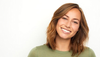 a patient in South Portland showing off her new veneers