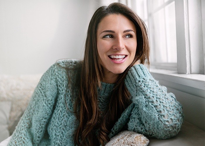 Woman smiling after wellness visit at Mind Your Mouth