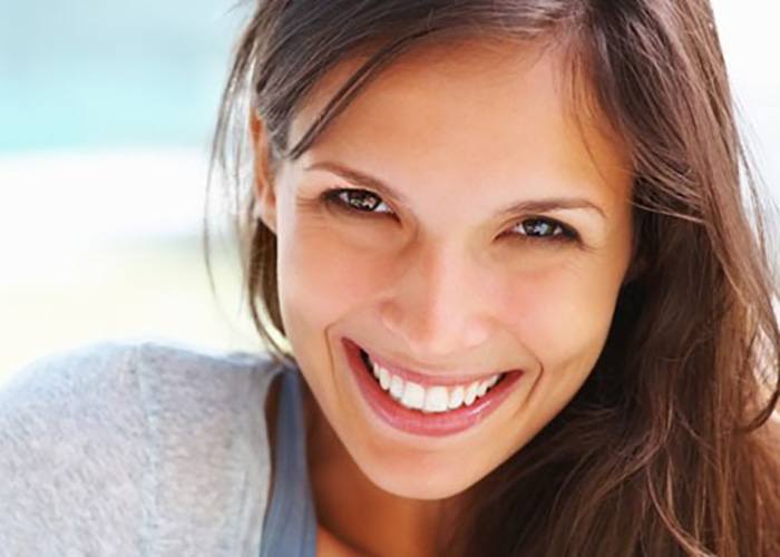 a patient smiling after receiving teeth whitening in South Portland, ME