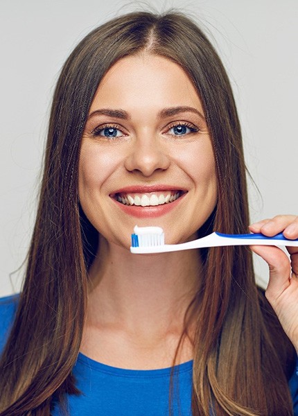 a patient brushing their teeth in South Portland, ME