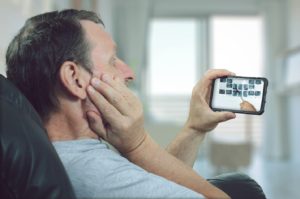  Man attending an appointment for teledentistry in South Portland, Maine