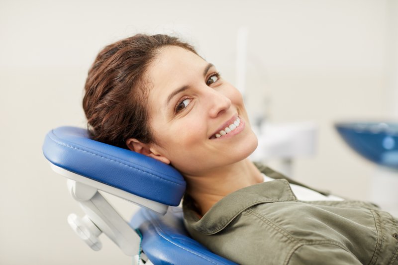 Female dental patient leaning back in chair