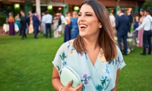 a person smiling while attending a wedding