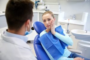 Patient with toothache, talking to dentist