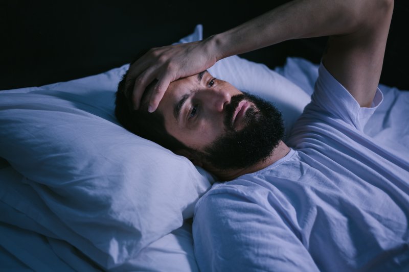 Man trying to sleep with sleep apnea