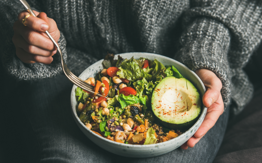 Woman holding healthy lunch bowl