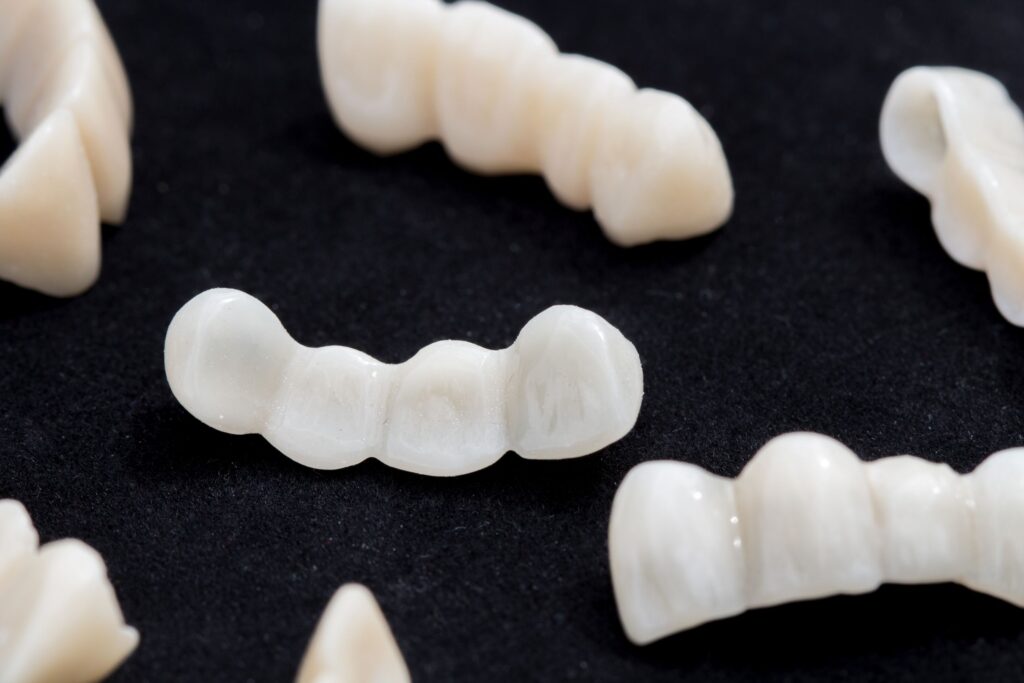 Several sets of temporary veneers on a black surface
